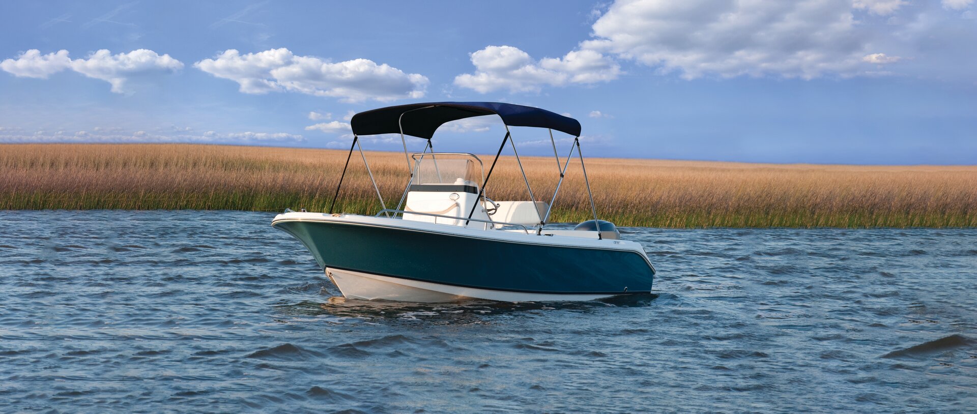 Navy 3-bow Bimini top installed on a white center-console boat