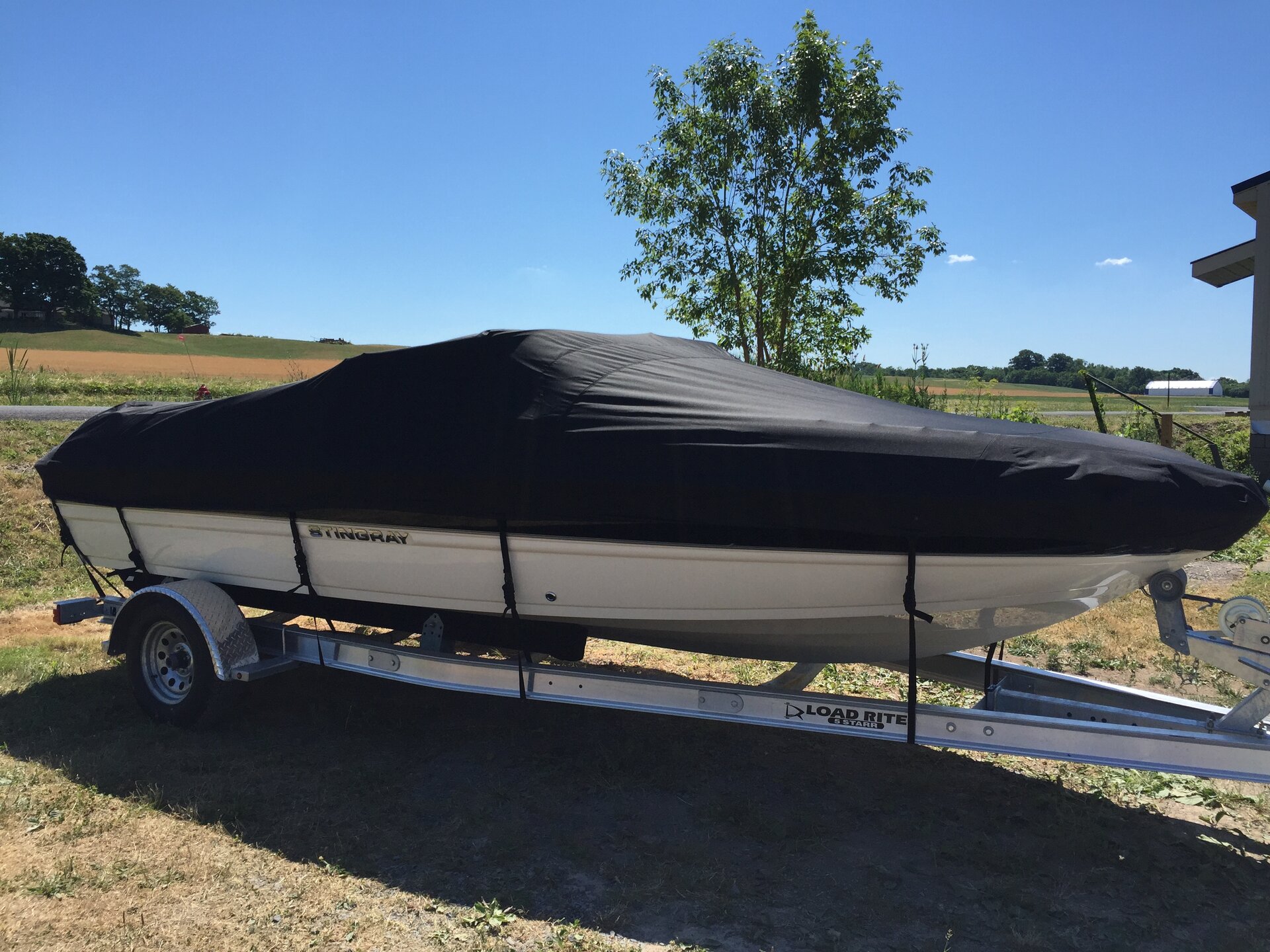Custom-fit cover installed on Stingray 198LX Sport Deck Inboard Outboard