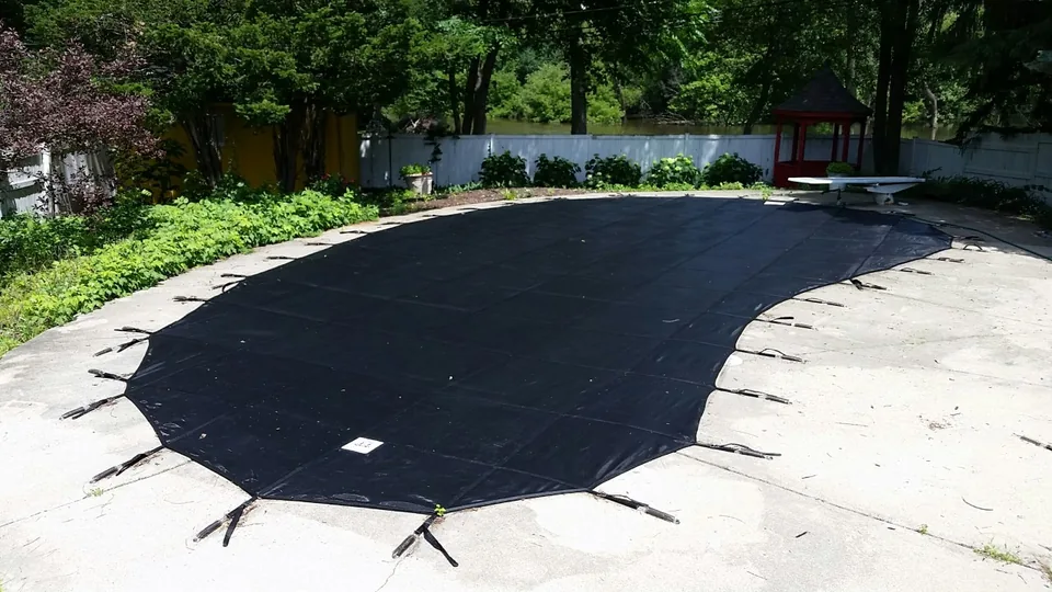 New black duplicate cover fitted over the same pool and surrounding deck