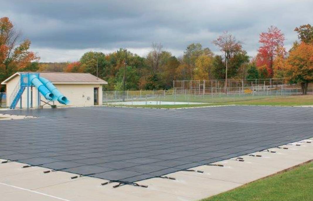 Black Commercial Coverlon Mesh installed over a large community pool