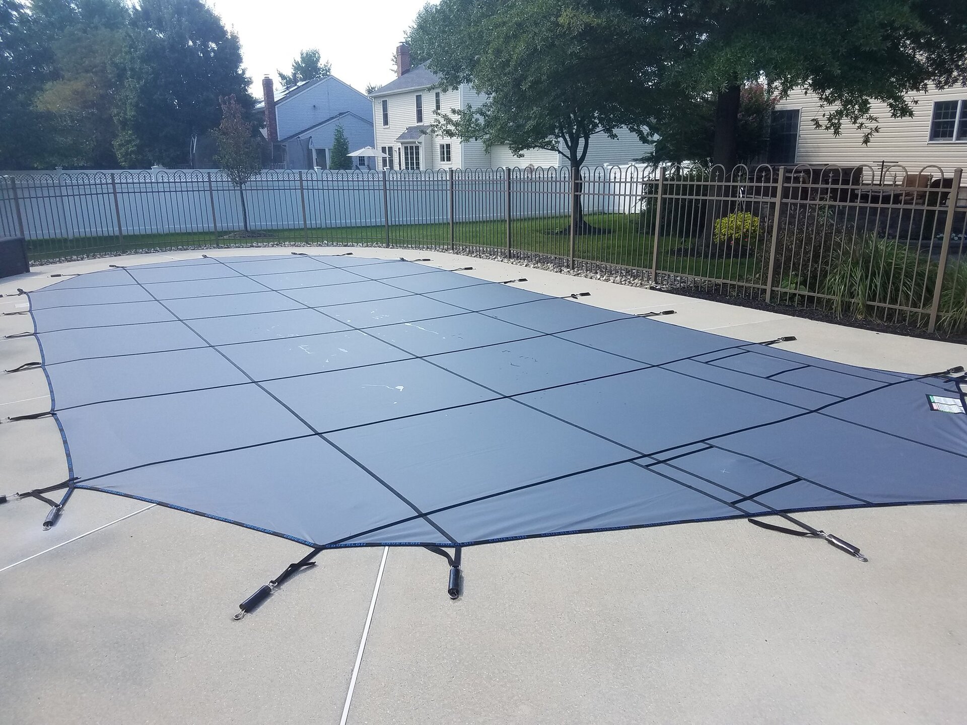 Gray Super Coverlon Solid cover with reinforced straps and springs secured to a concrete deck