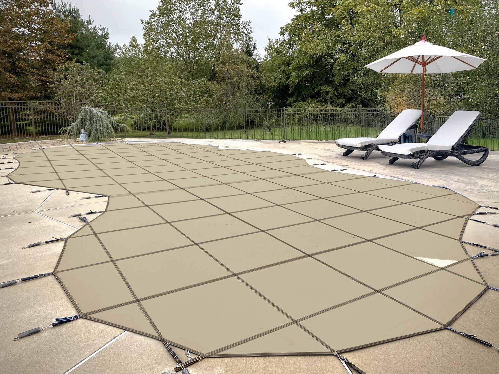 Tan Meyco PermaGuard solid safety cover fitted to a freeform backyard pool