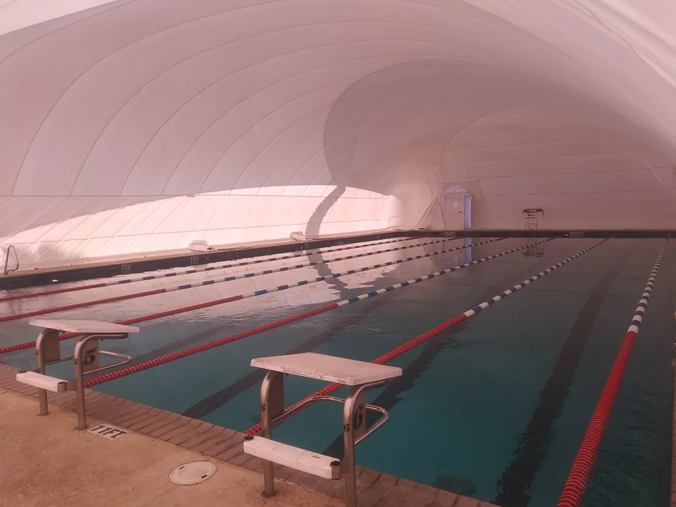 Lap pool operating inside a white commercial Ameri-Dome