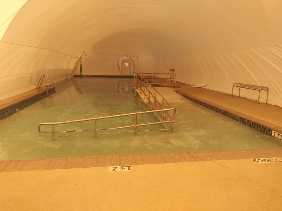 Accessible therapy pool with handrails inside a commercial Ameri-Dome