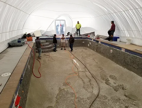 Workers and hoses inside the enclosed work area
