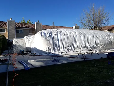 Inflated enclosure viewed across the yard