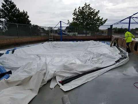 Crew spreading the dome fabric across the work area
