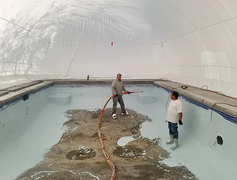Workers preparing the pool floor