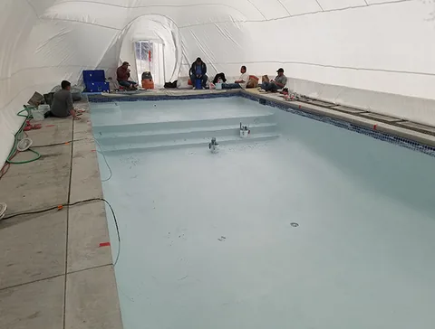 Crew gathered along the pool deck inside the dome