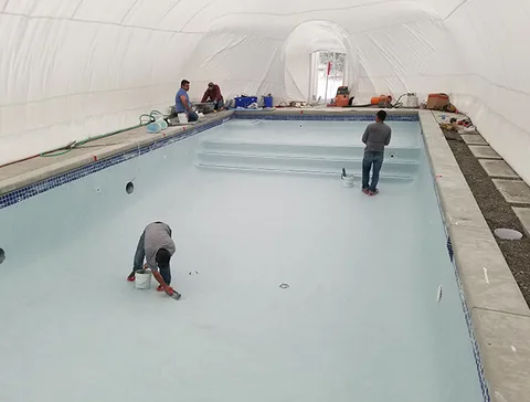 Renovation work along the edge of the pool