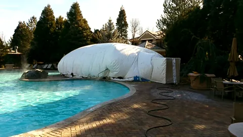 Construction dome viewed from across a pool