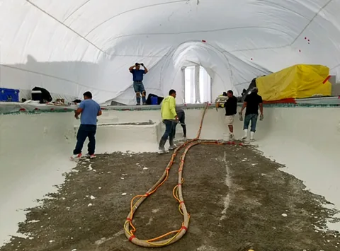 Crew working inside an inflated construction dome