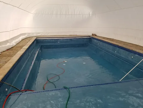 Pool filling beneath the inflated enclosure