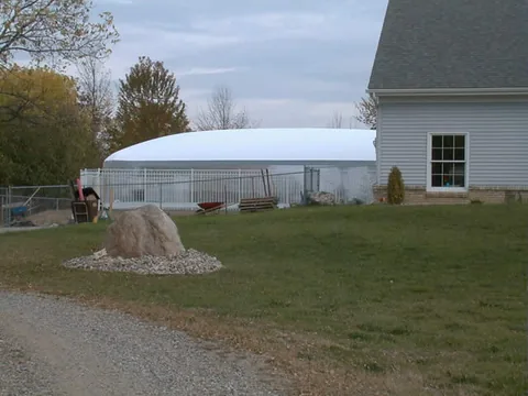 White Air Dome - Side profile, partially eclipsed by the house