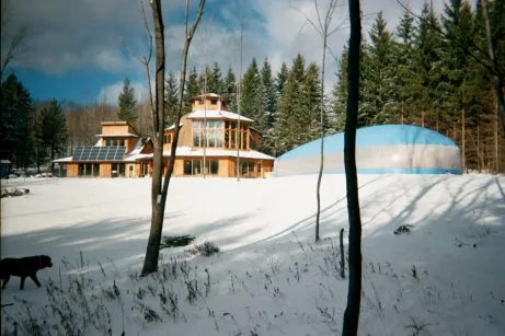 Blue pool dome next to an alpine cabin