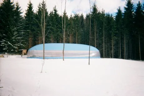 Side profile of a blue air dome in mountain snow