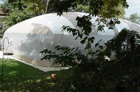 Exterior view of a tan and white striped Ameri-Dome