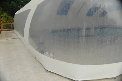 Long clear-sided wall of a pool dome