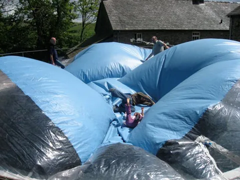 People playing on a play dome before full inflation