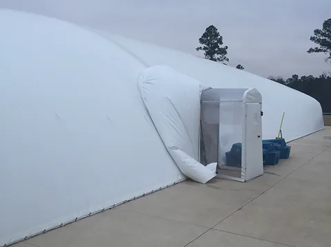 White commercial pool dome with an airlock entry