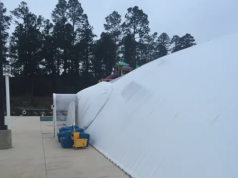 Long exterior side of a white commercial pool dome