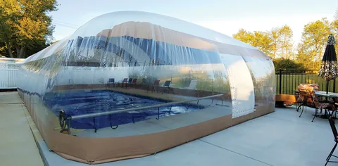 Blue and white striped pool dome exterior beside a patio