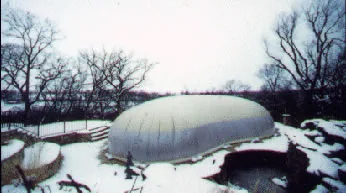 Large, tan commercial dome for a free-form pool, in the snom