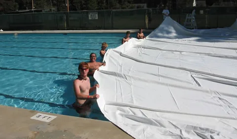 Pulling the dome across the swimming pool