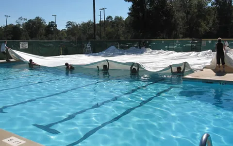 Unfolding the dome as it's pulled across the pool