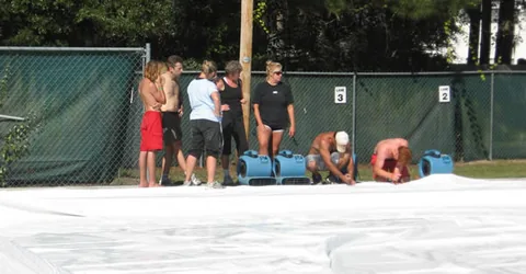Blowers being setup to inflate the swimming pool dome