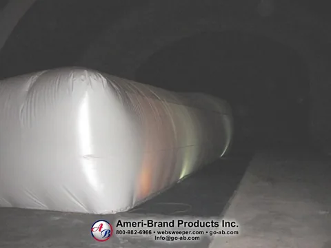 Angled end view of a long white inflatable pitching dome