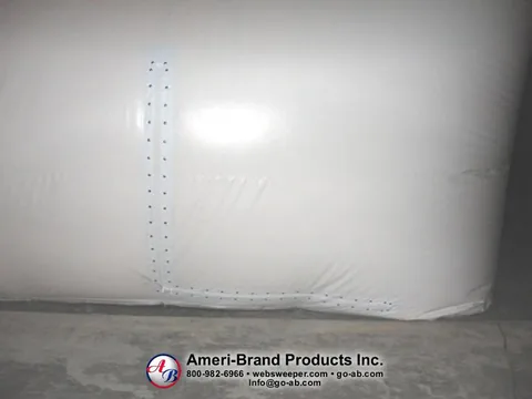 L-shaped fastener seam at the lower corner of a white pitching dome