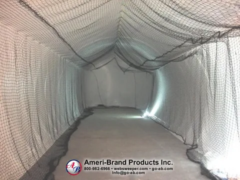 Empty netted batting lane inside a white inflatable pitching dome