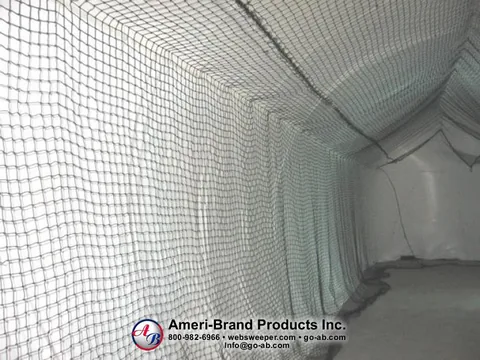 Lengthwise view of the netted batting lane inside a pitching dome