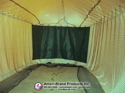 Dark impact screen across the end of the netted pitching lane