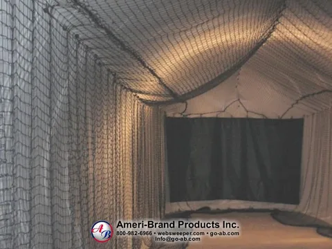 Netted pitching lane leading to a dark impact screen
