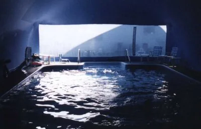 Indoor pool beneath an aqua Ameri-Dome with a clear end wall