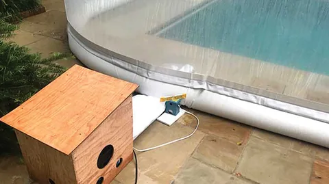 Pool dome blower beside the white water-tube base