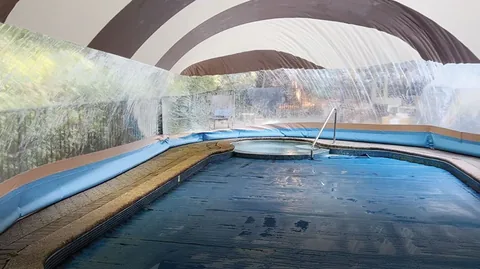 Striped pool dome interior with a water-tube base