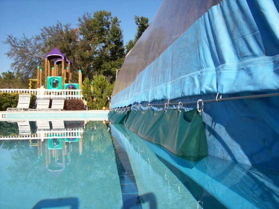 Ameri-Dome spanning part of a large pool with an alternative cable installation
