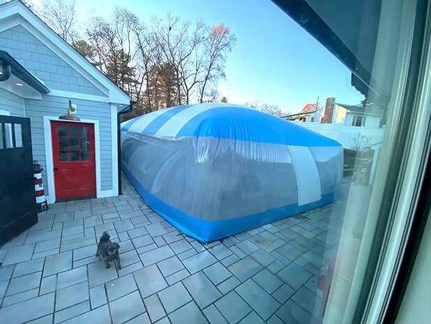 Blue-and-white residential Ameri-Dome viewed through a home's windows