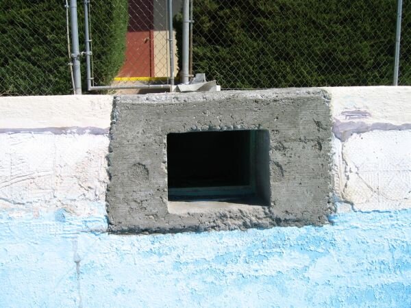 Skimmer cavity retrofitted with concrete.