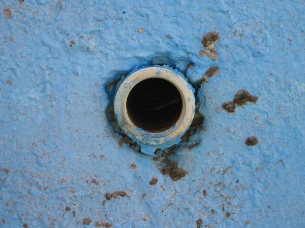 Water return line in wall of pool.
