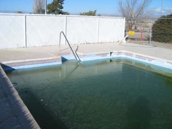 Pool has green water, pool and deck need repair.