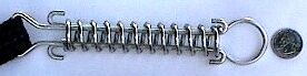 Stainless steel safety pool-cover spring attached to a black webbing strap