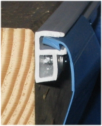 Cross-section of side-mount replacement track holding a liner bead