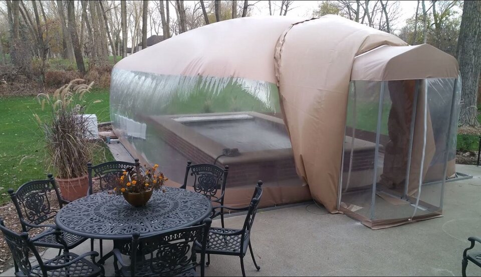 Air-supported Swim Spa Room with clear walls, a covered swim spa inside and an enclosed airlock entrance