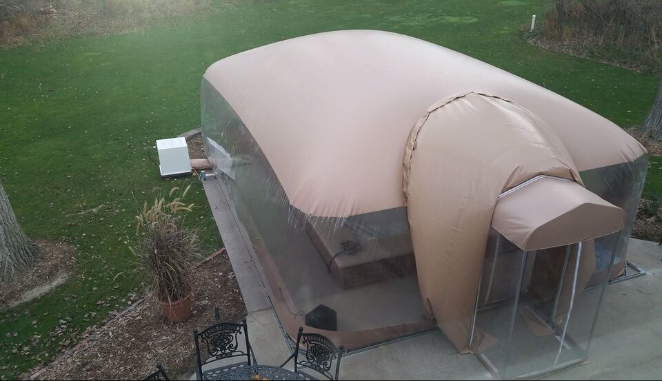 Elevated view of the enclosure roof, clear walls and separate airlock on the patio