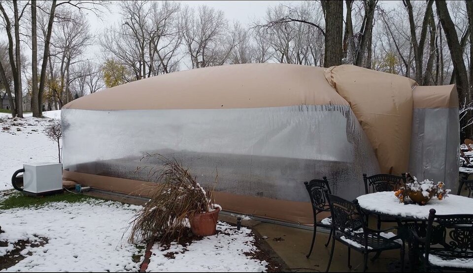 The clear side wall, airlock and equipment beside the enclosure.