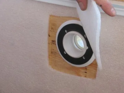 Wall padding cut to expose the fitting